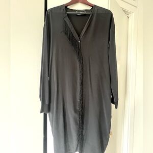 100% silk black dress w/ fringe detail. Looks great with a cinched belt.